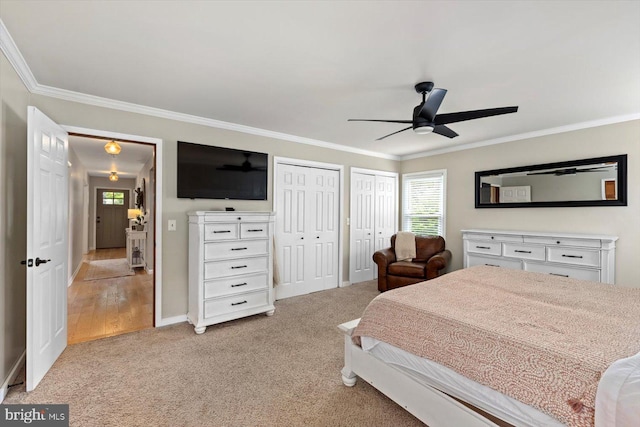 9 Tally Ho Dr, Fredericksburg, VA 22405 - bedroom with two closets, ornamental molding, light carpet, ceiling fan, and baseboards