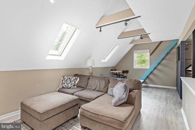 9 Tally Ho Dr, Fredericksburg, VA 22405 - living area with track lighting, a skylight, wood finished floors, lofted ceiling, and baseboards
