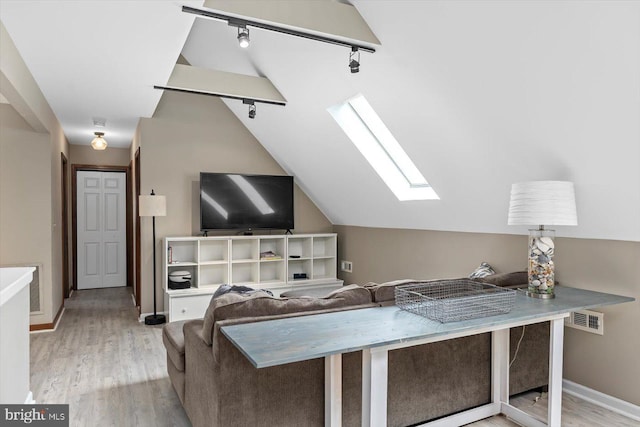 9 Tally Ho Dr, Fredericksburg, VA 22405 - living room featuring track lighting, a skylight, lofted ceiling, light wood finished floors, and baseboards