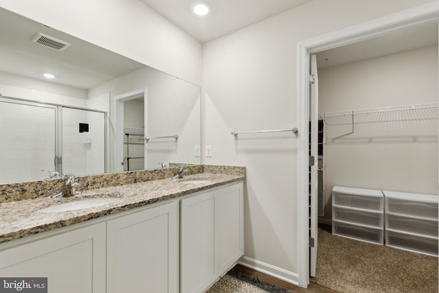 298 Forest Edge Ave, La Plata, MD 20646 - bathroom with double vanity, a spacious closet, a shower stall, baseboards, and recessed lighting