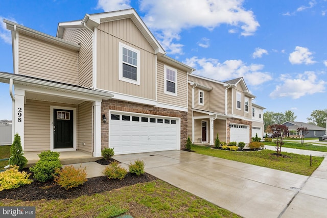 298 Forest Edge Ave, La Plata, MD 20646 - townhome / multi-family property with an attached garage, driveway, stone siding, covered porch, and board and batten siding