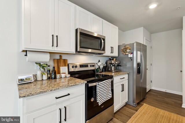 298 Forest Edge Ave, La Plata, MD 20646 - kitchen with stainless steel appliances, wood finished floors, white cabinetry, and light stone counters