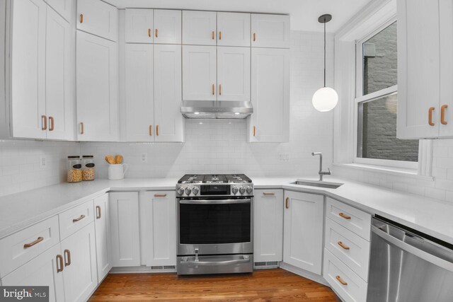 908 Westminster St NW, Washington, DC 20001 - kitchen featuring appliances with stainless steel finishes, a sink, under cabinet range hood, and white cabinetry
