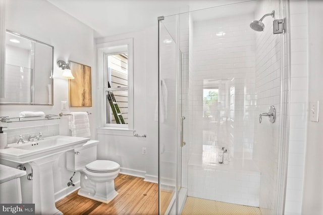 908 Westminster St NW, Washington, DC 20001 - full bathroom with toilet, wood finished floors, a shower stall, and healthy amount of natural light