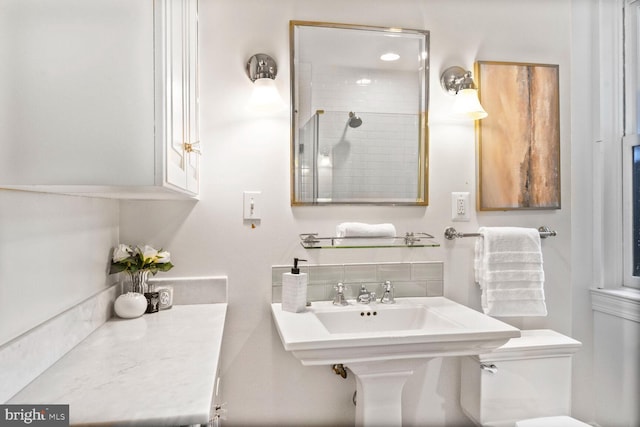908 Westminster St NW, Washington, DC 20001 - bathroom featuring decorative backsplash, toilet, a tile shower, and a sink
