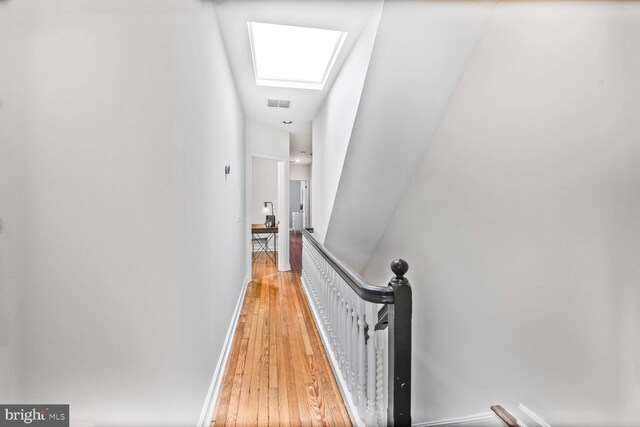 908 Westminster St NW, Washington, DC 20001 - hallway featuring an upstairs landing, light wood-type flooring, a skylight, and baseboards