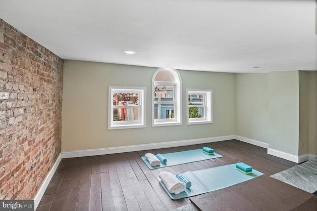 908 Westminster St NW, Washington, DC 20001 - exercise room with wood-type flooring, baseboards, and brick wall