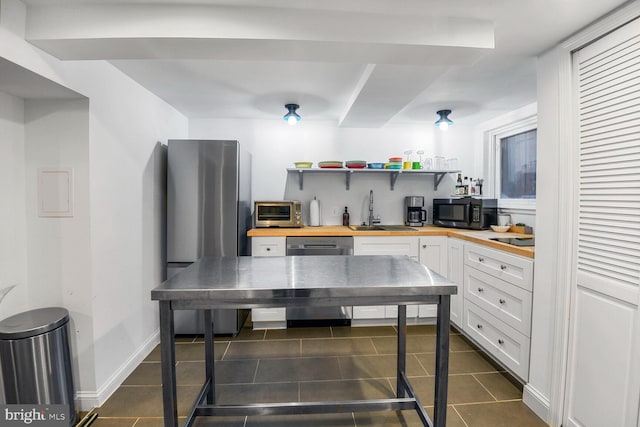 908 Westminster St NW, Washington, DC 20001 - kitchen with butcher block countertops, appliances with stainless steel finishes, a sink, and open shelves