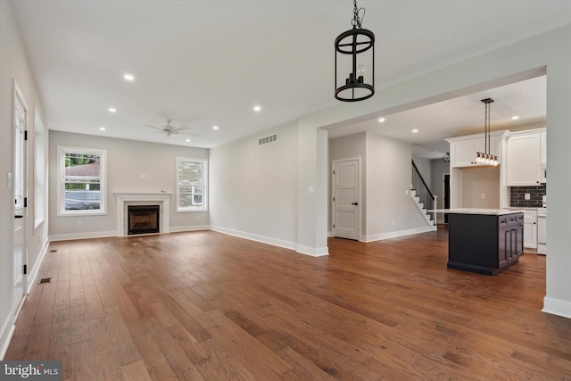 721 Walden Rd, Elkins Park, PA 19027 - unfurnished living room with ceiling fan, dark wood finished floors, recessed lighting, stairway, and a fireplace
