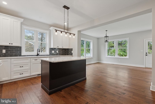 721 Walden Rd, Elkins Park, PA 19027 - kitchen featuring decorative backsplash, dark wood finished floors, a sink, a kitchen island, and healthy amount of natural light