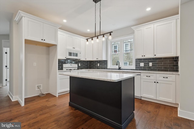 721 Walden Rd, Elkins Park, PA 19027 - kitchen featuring white microwave, range, white cabinetry, tasteful backsplash, and a kitchen island