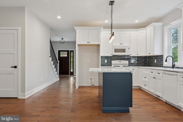 721 Walden Rd, Elkins Park, PA 19027 - kitchen featuring white appliances, a sink, a center island, decorative backsplash, and dark wood-style flooring