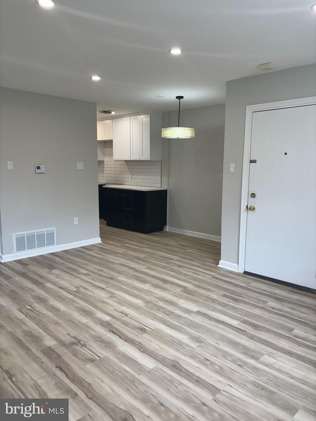 6901 Valley Ave Unit I1, Philadelphia, PA 19128 - unfurnished living room featuring baseboards, light wood-type flooring, and recessed lighting
