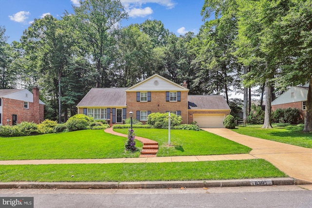 8305 Toll House Rd, Annandale, VA 22003 - view of front of property with brick siding, an attached garage, a front lawn, and driveway