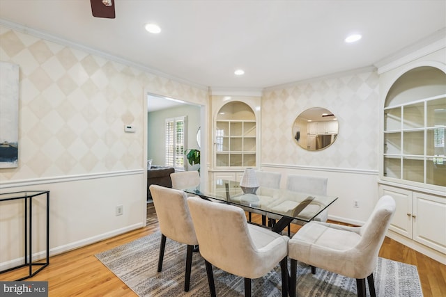 8305 Toll House Rd, Annandale, VA 22003 - dining area with wallpapered walls, crown molding, an accent wall, light wood-style flooring, and recessed lighting