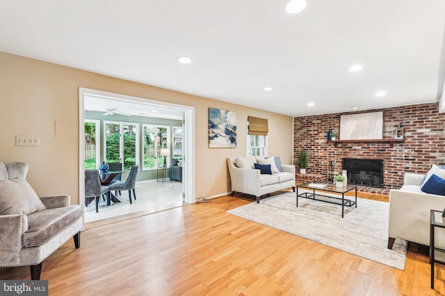 8305 Toll House Rd, Annandale, VA 22003 - living area featuring light wood-style flooring, a brick fireplace, and recessed lighting