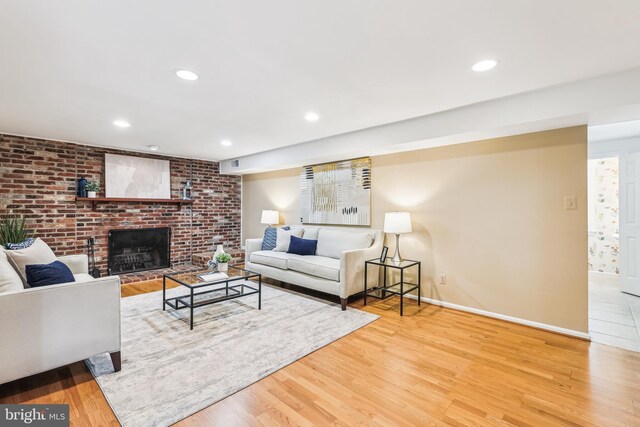 8305 Toll House Rd, Annandale, VA 22003 - living area with wood finished floors, a brick fireplace, and recessed lighting