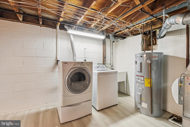 8305 Toll House Rd, Annandale, VA 22003 - laundry area featuring water heater, independent washer and dryer, light wood-style floors, and concrete block wall