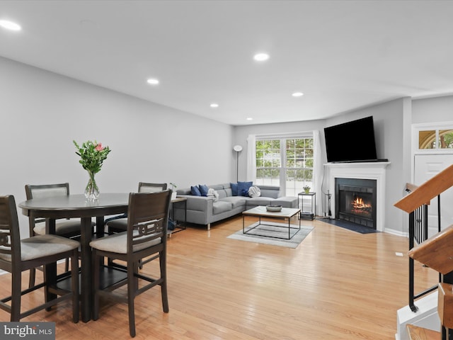 12215 Wye Oak Commons Cir Unit 66, Burke, VA 22015 - dining area featuring a fireplace with flush hearth, light wood-type flooring, recessed lighting, and stairs