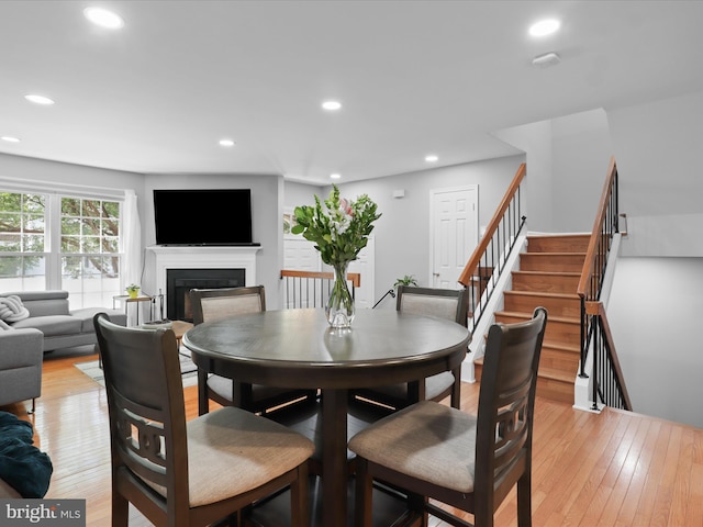 12215 Wye Oak Commons Cir Unit 66, Burke, VA 22015 - dining space featuring a glass covered fireplace, light wood-type flooring, recessed lighting, and stairway
