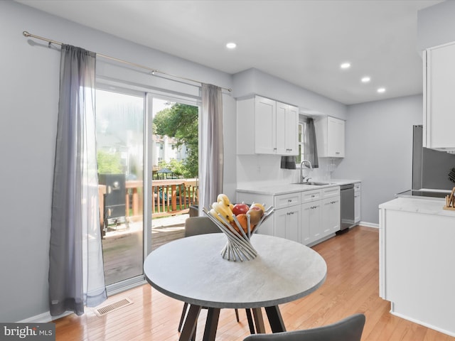 12215 Wye Oak Commons Cir Unit 66, Burke, VA 22015 - kitchen featuring light countertops, a sink, white cabinetry, light wood finished floors, and recessed lighting