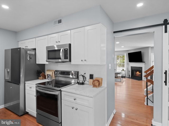 12215 Wye Oak Commons Cir Unit 66, Burke, VA 22015 - kitchen featuring appliances with stainless steel finishes, light wood-style floors, recessed lighting, and white cabinetry