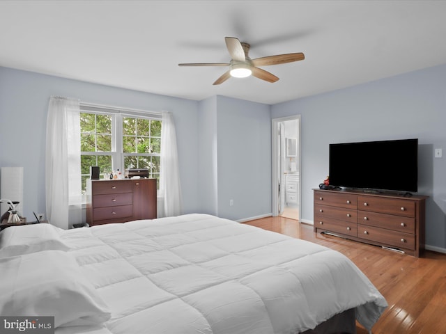 12215 Wye Oak Commons Cir Unit 66, Burke, VA 22015 - bedroom with light wood finished floors, baseboards, ceiling fan, and connected bathroom