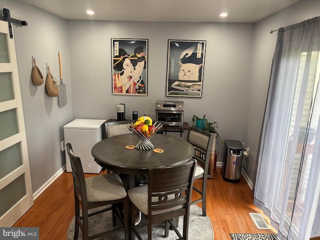 12215 Wye Oak Commons Cir Unit 66, Burke, VA 22015 - dining space featuring a barn door, light wood-style floors, recessed lighting, and baseboards