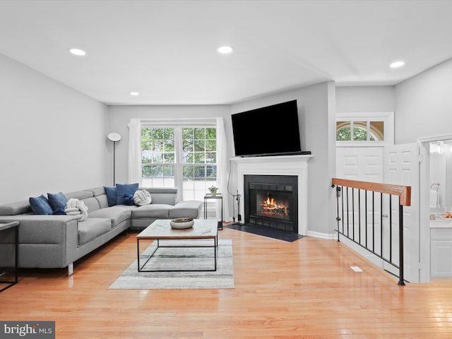 12215 Wye Oak Commons Cir Unit 66, Burke, VA 22015 - living room featuring plenty of natural light, wood finished floors, a fireplace with flush hearth, and recessed lighting