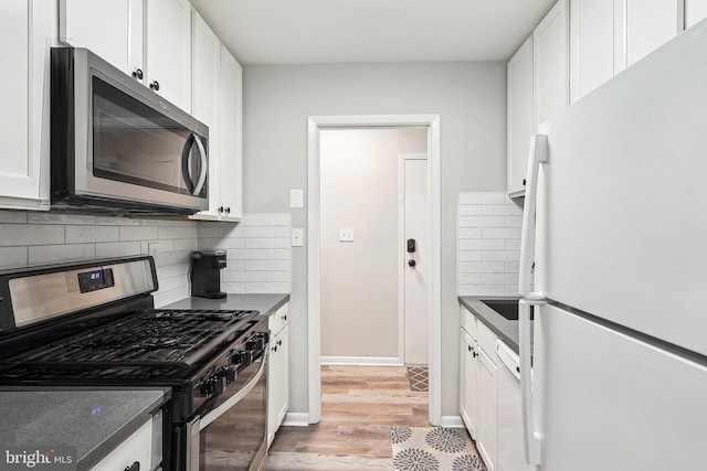 3814 Lyndhurst Dr Unit 203, Fairfax, VA 22031 - kitchen with stainless steel appliances, white cabinetry, light wood-type flooring, and decorative backsplash