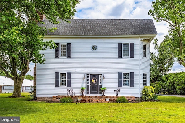 8807 Woodland Ferry Rd, Laurel, DE 19956 - view of front facade with a front yard, a chimney, and roof with shingles