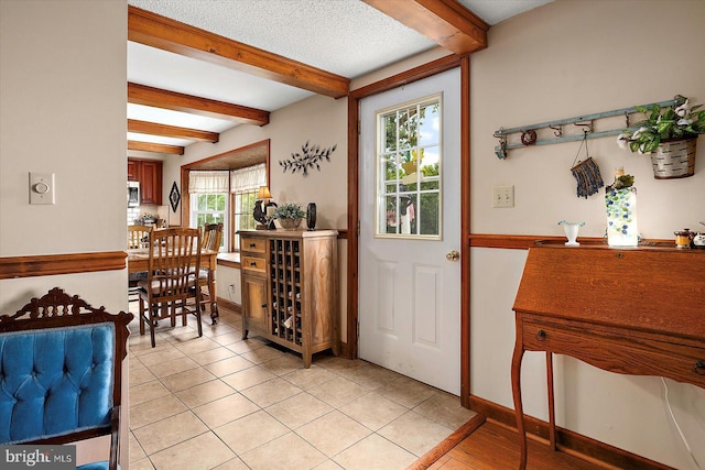 8807 Woodland Ferry Rd, Laurel, DE 19956 - dining room with beam ceiling, baseboards, and light tile patterned floors
