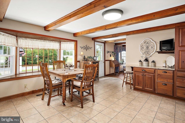 8807 Woodland Ferry Rd, Laurel, DE 19956 - dining room featuring light tile patterned floors, beam ceiling, baseboards, and plenty of natural light