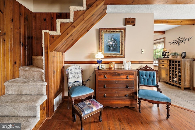 8807 Woodland Ferry Rd, Laurel, DE 19956 - sitting room with wood finished floors, beam ceiling, and wood walls