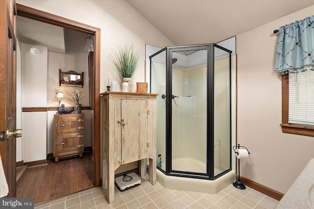 8807 Woodland Ferry Rd, Laurel, DE 19956 - bathroom with a shower stall, vaulted ceiling, and baseboards