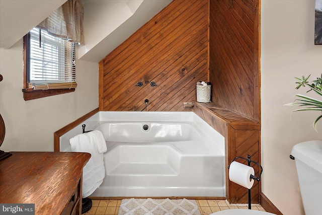 8807 Woodland Ferry Rd, Laurel, DE 19956 - bathroom featuring toilet, a garden tub, and tile patterned flooring