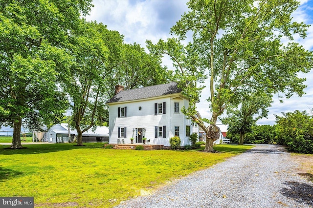 8807 Woodland Ferry Rd, Laurel, DE 19956 - colonial inspired home with a chimney, a front lawn, and driveway