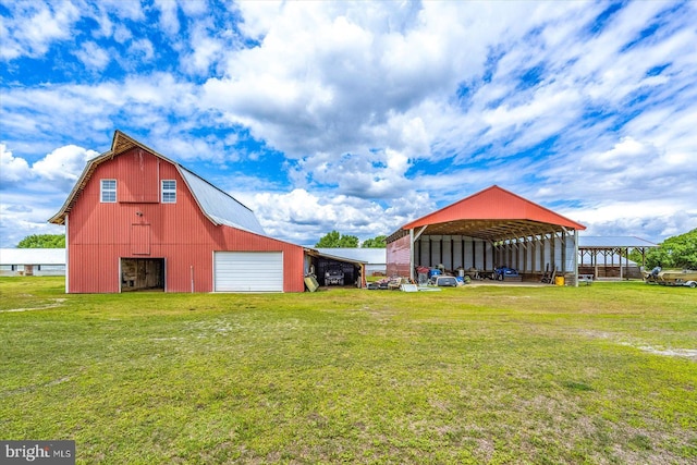 8807 Woodland Ferry Rd, Laurel, DE 19956 - view of green lawn with a detached garage, driveway, an outbuilding, and a barn