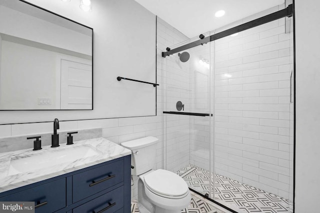 1368 Bryant St NE Unit 4, Washington, DC 20018 - bathroom featuring toilet, tile walls, a stall shower, and vanity