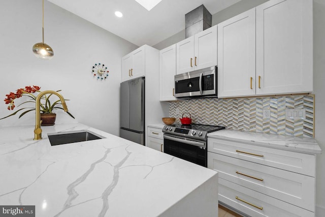1368 Bryant St NE Unit 4, Washington, DC 20018 - kitchen with stainless steel appliances, tasteful backsplash, white cabinets, pendant lighting, and light stone countertops