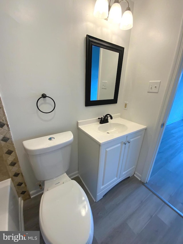 508 Boysenberry Ln, Frederick, MD 21703 - full bath featuring wood finished floors, toilet, vanity, and baseboards