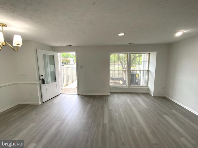 508 Boysenberry Ln, Frederick, MD 21703 - unfurnished living room with baseboards, wood finished floors, a chandelier, a textured ceiling, and recessed lighting