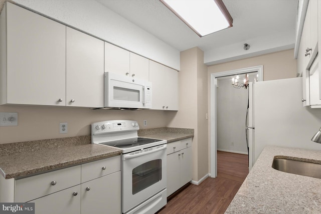 5802 Nicholson Ln Unit 2-407, Rockville, MD 20852 - kitchen featuring white appliances, a sink, dark wood-style floors, white cabinetry, and a chandelier