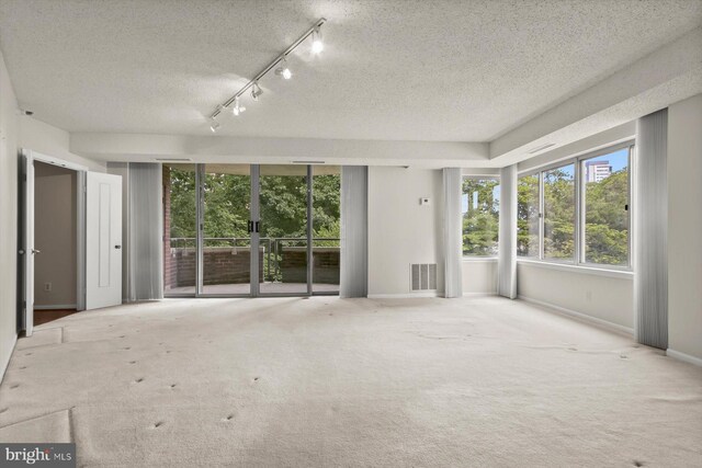 5802 Nicholson Ln Unit 2-407, Rockville, MD 20852 - carpeted empty room featuring a textured ceiling, plenty of natural light, and baseboards
