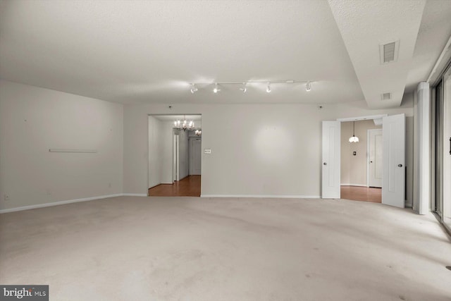 5802 Nicholson Ln Unit 2-407, Rockville, MD 20852 - spare room featuring a chandelier, light carpet, baseboards, and a textured ceiling