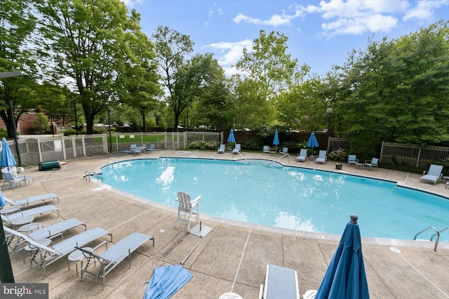 5802 Nicholson Ln Unit 2-407, Rockville, MD 20852 - community pool with a patio and view of wooded area