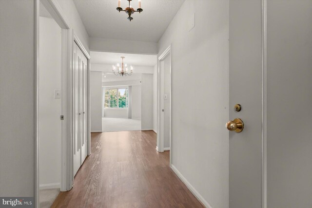 5802 Nicholson Ln Unit 2-407, Rockville, MD 20852 - hallway with a chandelier, wood finished floors, and baseboards