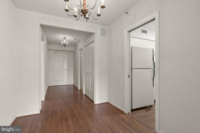 5802 Nicholson Ln Unit 2-407, Rockville, MD 20852 - hallway with a chandelier, wood finished floors, baseboards, and a textured ceiling