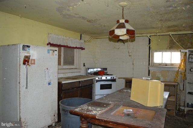 2901 Edison Hwy, Baltimore, MD 21213 - kitchen featuring white appliances and unfinished concrete floors