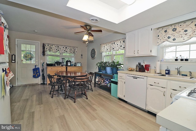 2028 Brookdale Dr, Forked River, NJ 08731 - kitchen featuring white dishwasher, a sink, light wood finished floors, white cabinetry, and a ceiling fan
